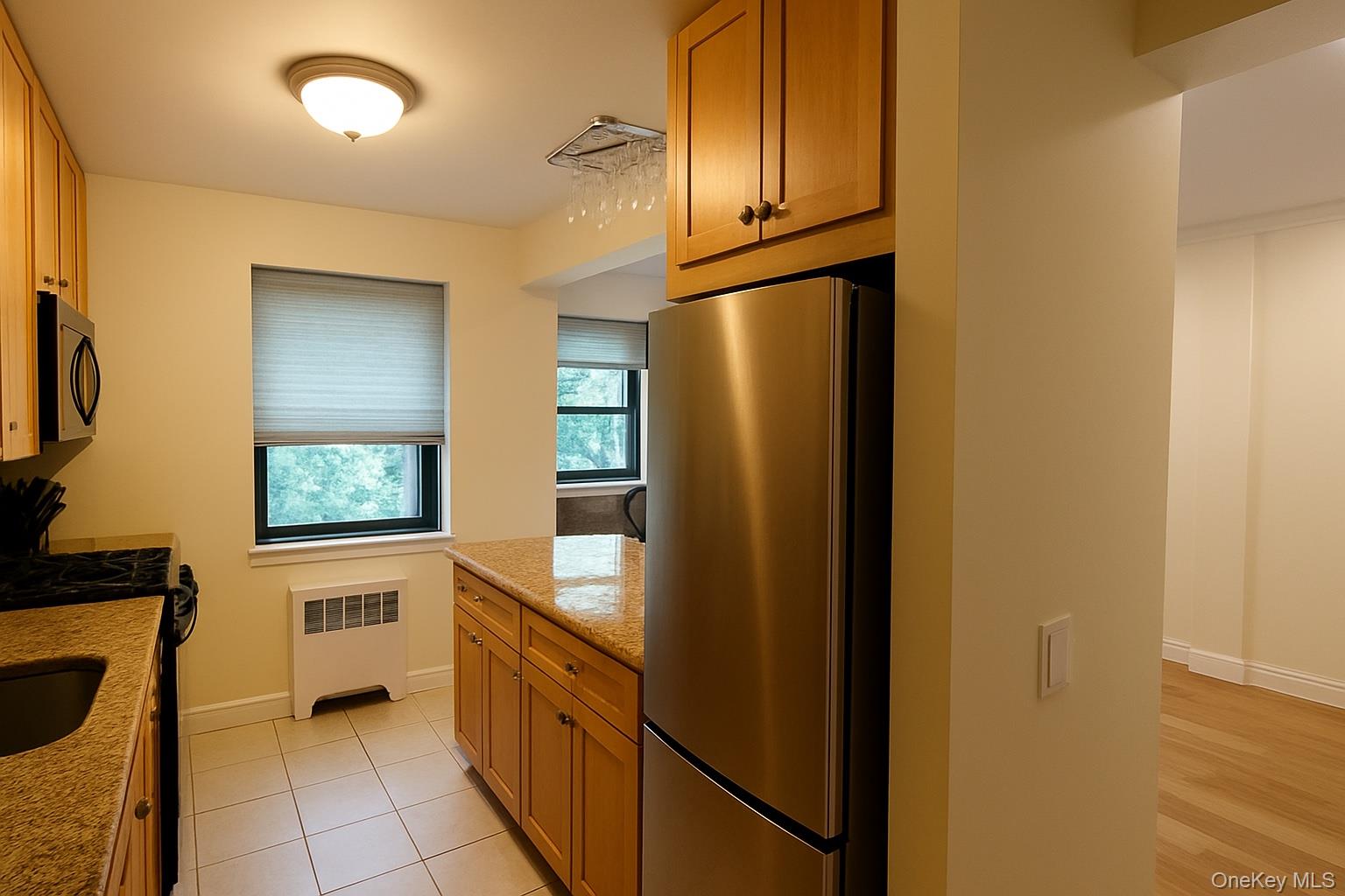 60 White Oak Street, Unit 2H New Rochelle, NY 10801 - Photo 7 of 15 a kitchen with stainless steel appliances granite countertop a refrigerator and a sink