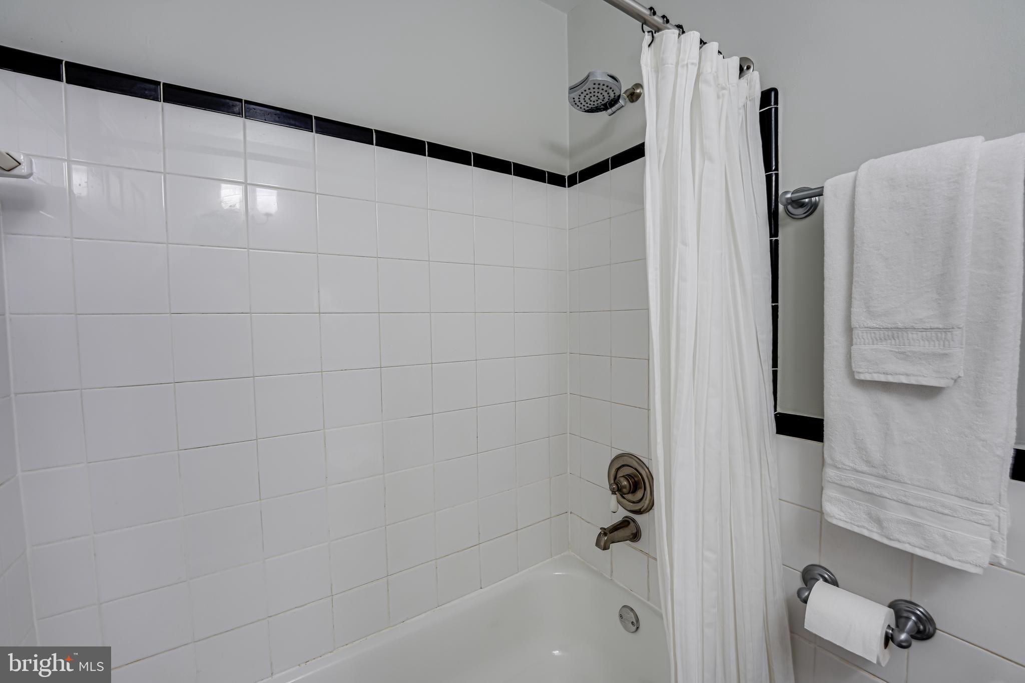 1441 Euclid Street Northwest, Unit 301 Washington, DC 20009 - Photo 14 of 18 a bathroom with a shower and a tub