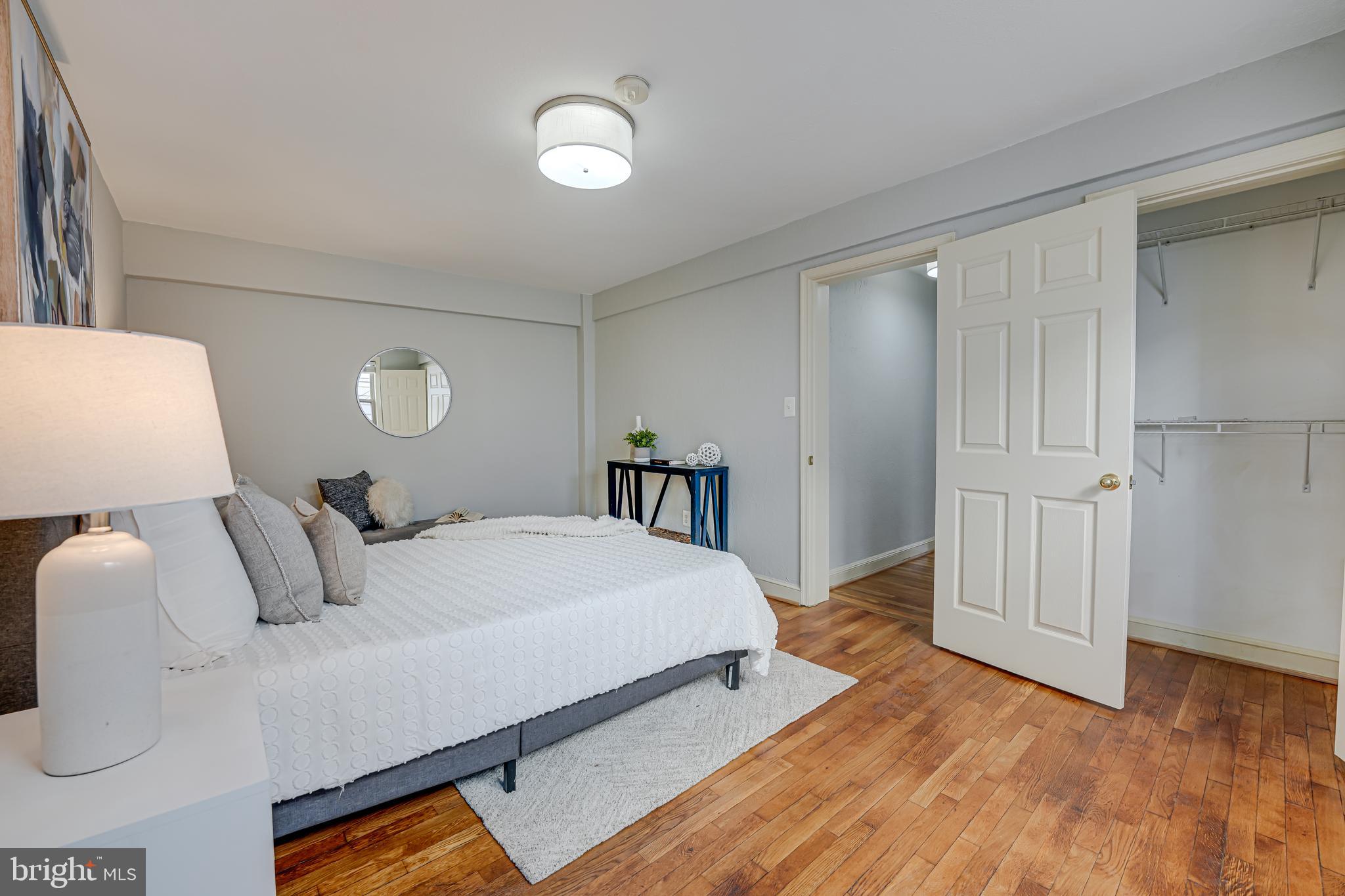 1441 Euclid Street Northwest, Unit 301 Washington, DC 20009 - Photo 16 of 18 a bedroom with a bed and a lamp