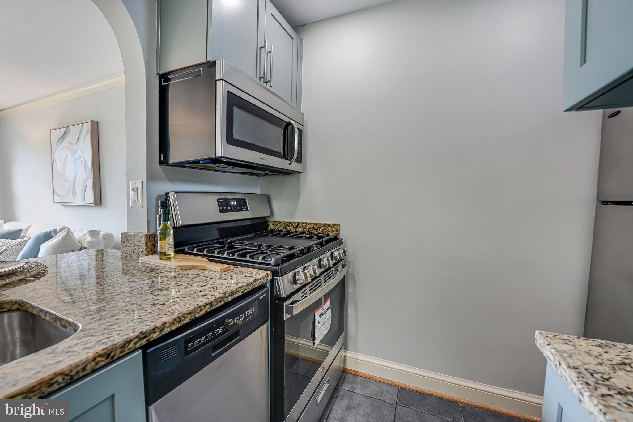 1441 Euclid Street Northwest, Unit 301 Washington, DC 20009 - Photo 7 of 18 a kitchen with a stove and a microwave