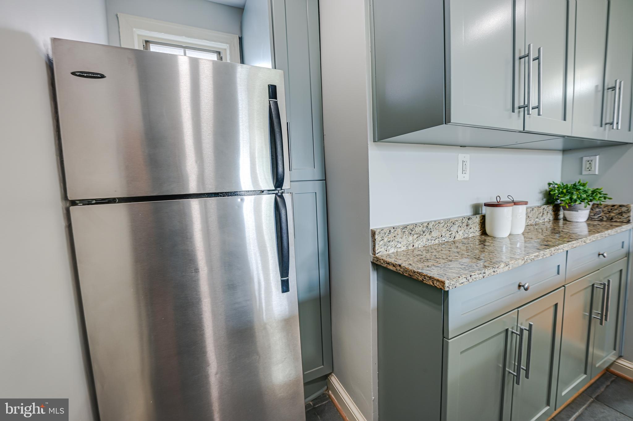 1441 Euclid Street Northwest, Unit 301 Washington, DC 20009 - Photo 8 of 18 a kitchen with stainless steel appliances granite countertop a refrigerator and a sink
