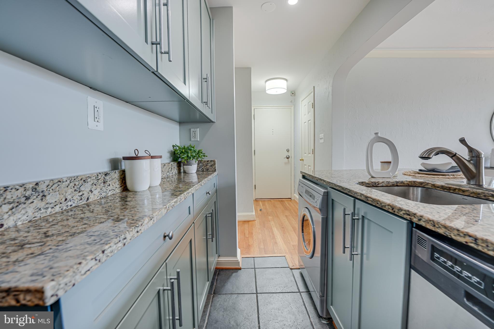 1441 Euclid Street Northwest, Unit 301 Washington, DC 20009 - Photo 9 of 18 a kitchen with stainless steel appliances granite countertop a sink and a stove