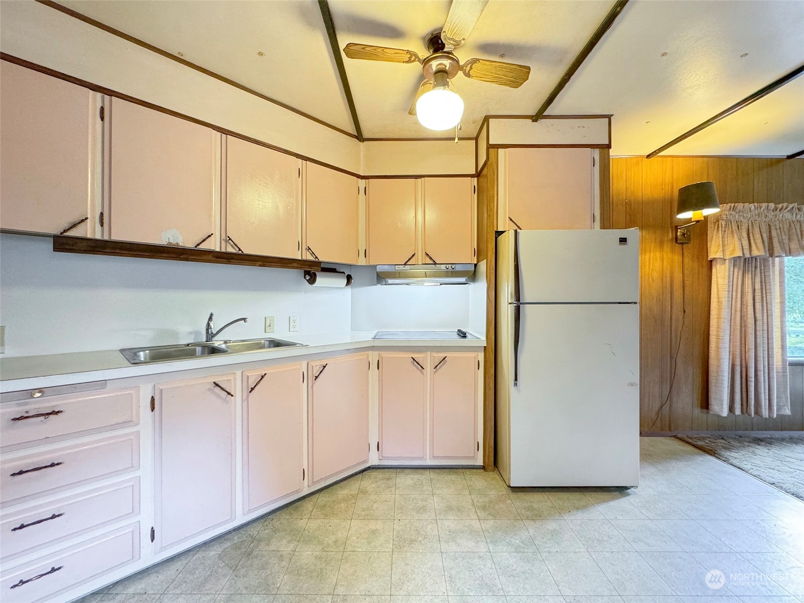 183 Spath Road Sequim, WA 98382 - Photo 16 of 40 a kitchen with cabinets a refrigerator and a sink