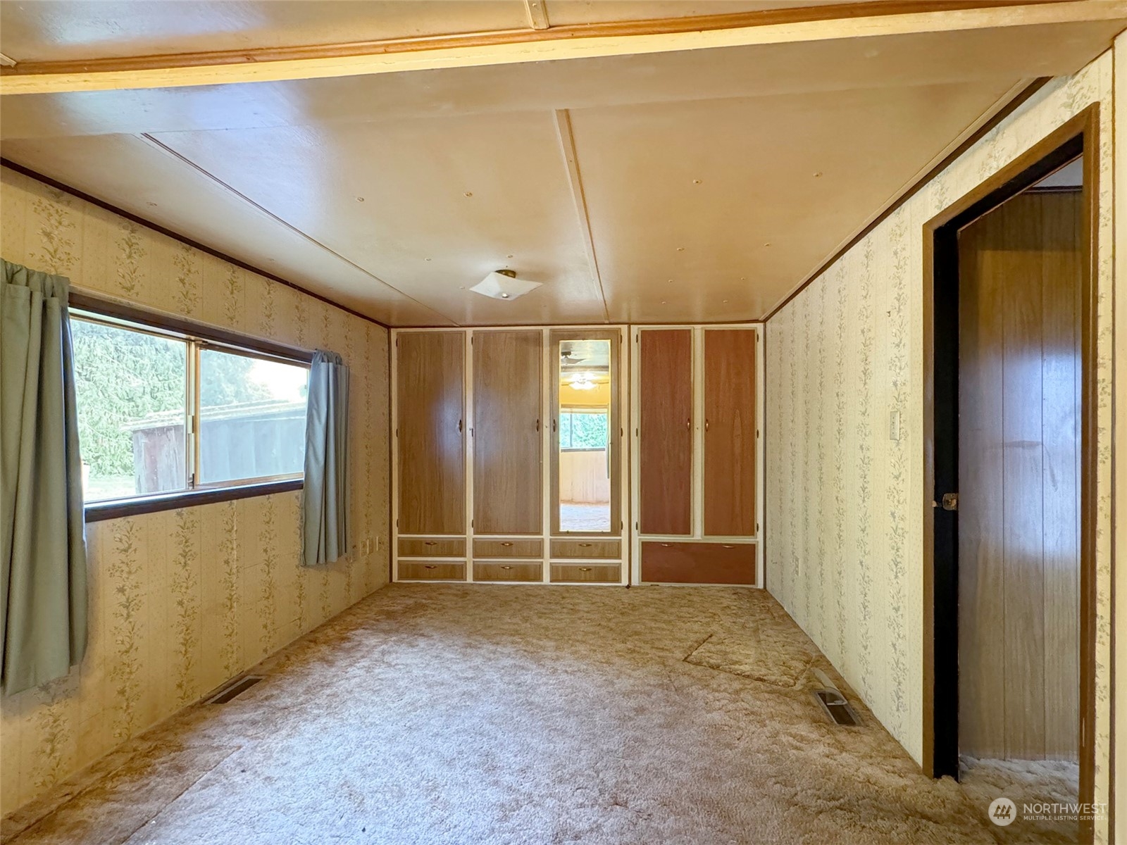 183 Spath Road Sequim, WA 98382 - Photo 21 of 40 a view of an empty room with wooden floor and a window