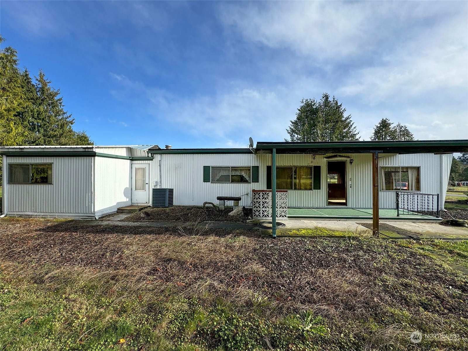 183 Spath Road Sequim, WA 98382 - Photo 7 of 40 a view of a house with backyard sitting area and garden