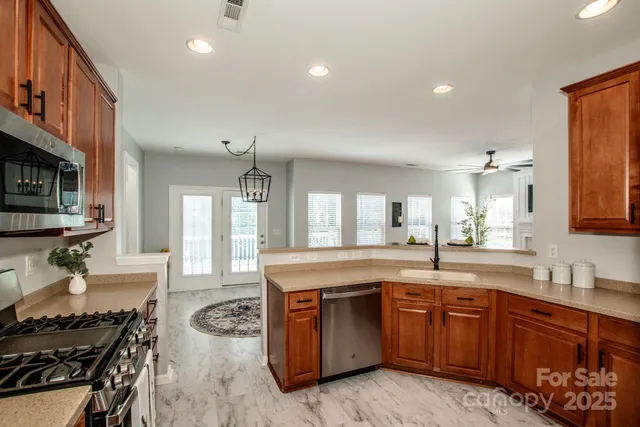 a kitchen with a stove a sink and a refrigerator
