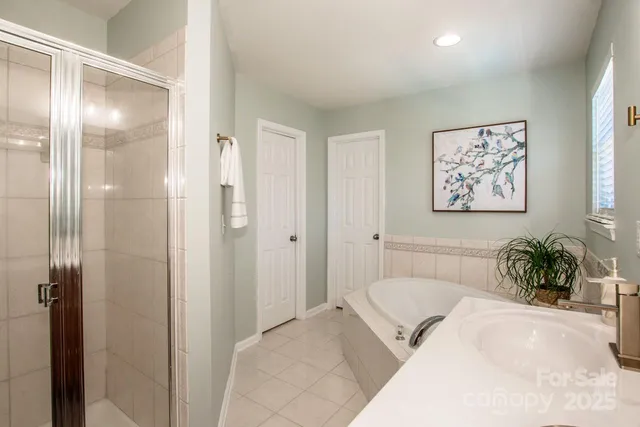 a spacious bedroom with a bed and a chandelier