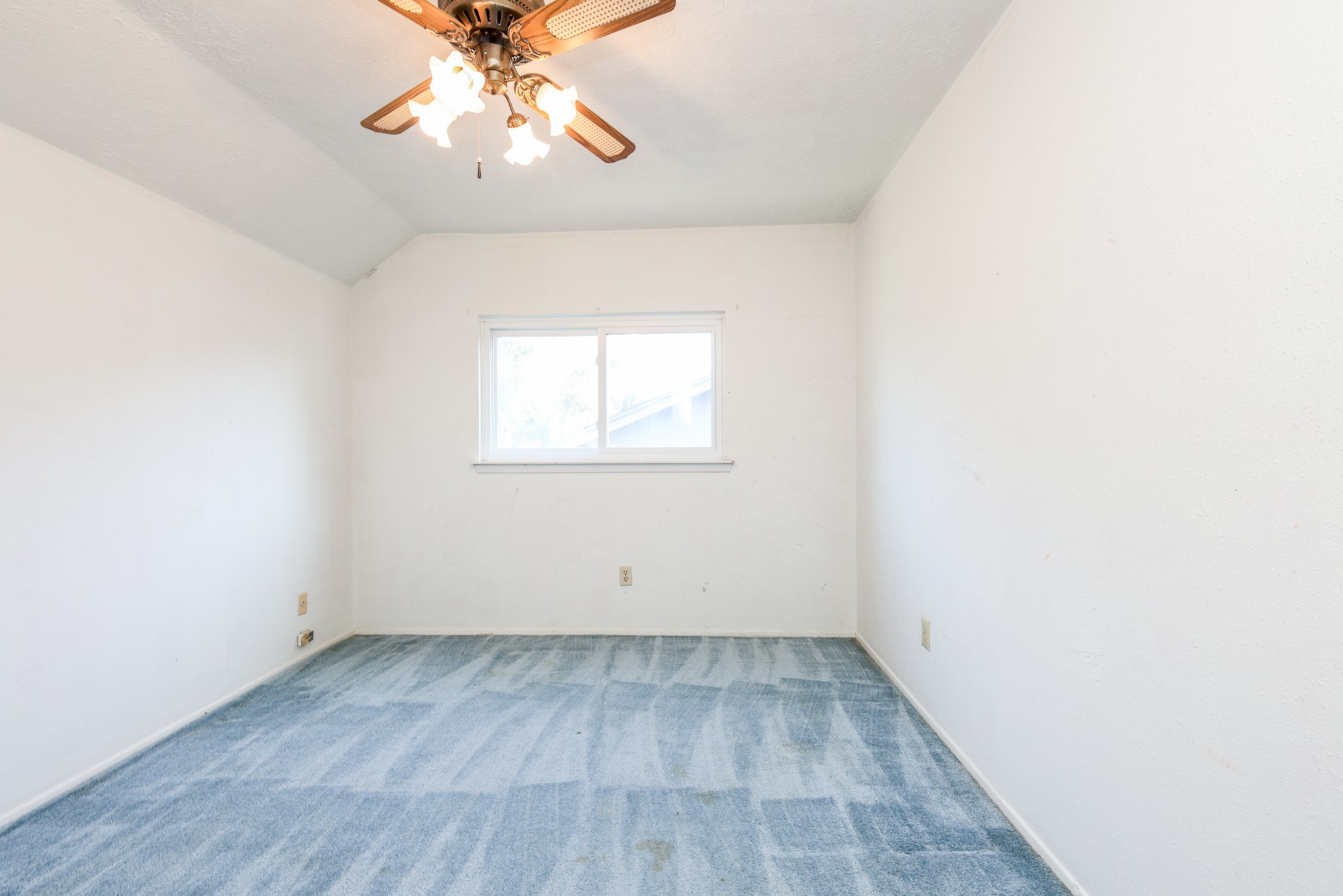 21422 Bridgepoint Lane Spring, TX 77388 - Photo 17 of 20 Bright 3rd upstiars bedroom with a soft blue carpet, white walls, and a ceiling fan, offering a cozy and inviting atmosphere.
