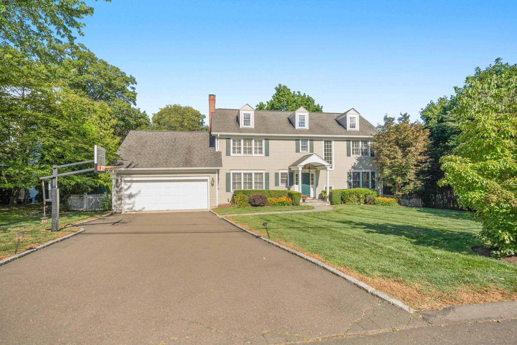 a front view of a house with a yard and fountain