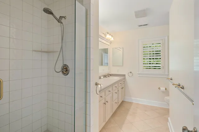 a bathroom with a granite countertop sink a mirror a shower and a bathtub