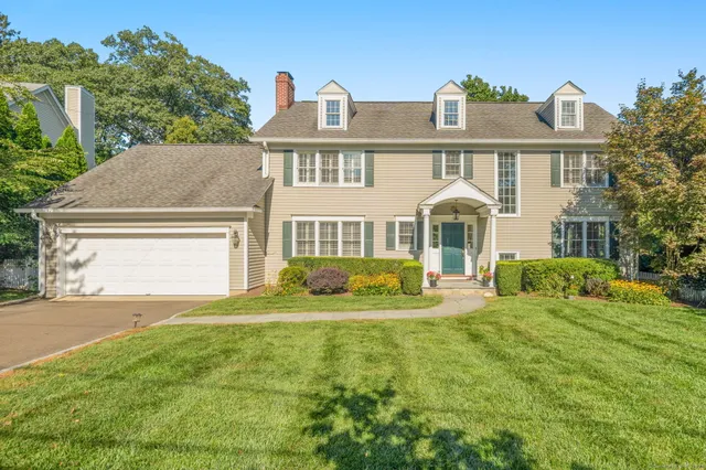 a front view of a house with a yard and porch