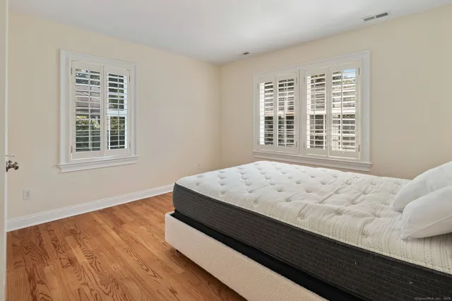 a bed sitting in a bedroom next to a window