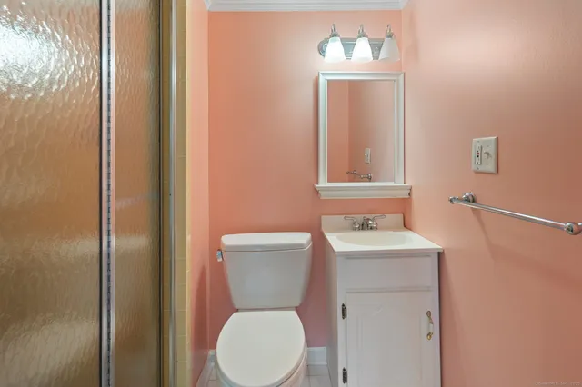 a white toilet sitting next to a bathroom sink