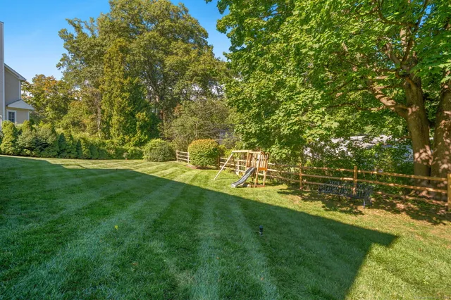 a view of yard with swimming pool and green space
