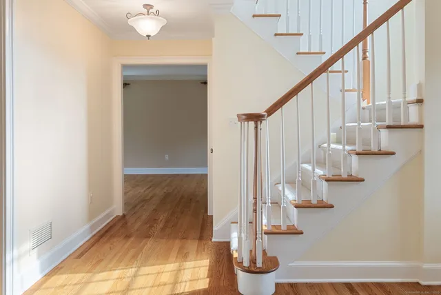a view of entryway and hall with wooden floor