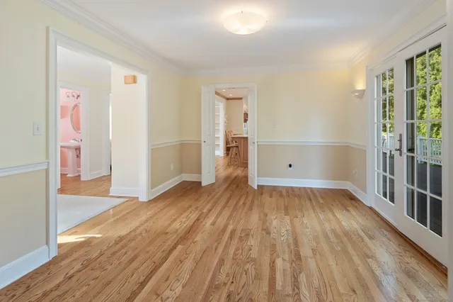 wooden floor in an empty room with a window