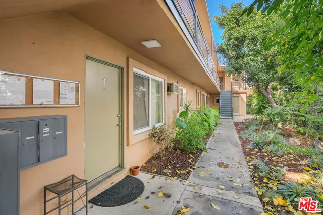a house with potted plant in front of it