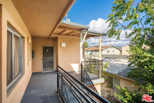a view of a balcony with wooden floor and fence