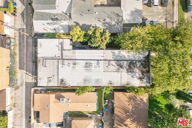 an aerial view of a house with a yard