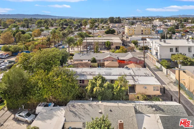 an aerial view of residential houses with outdoor space