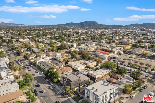 a view of backyard with swimming pool and seating space