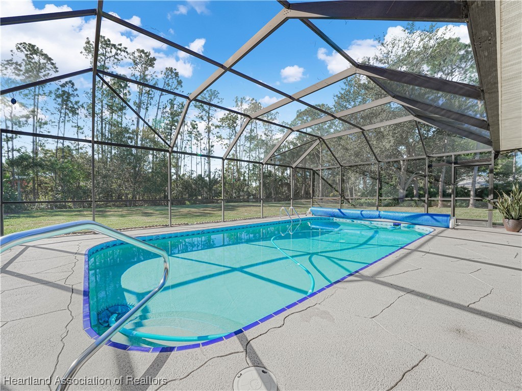 3206 Divot Road Sebring, FL 33872 - Photo 30 of 40 Sparkling 14x27 caged, solar-heated pool