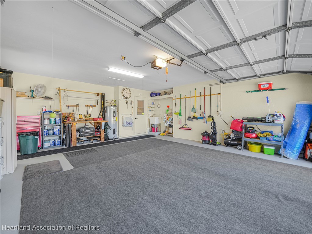 3206 Divot Road Sebring, FL 33872 - Photo 33 of 40 2-Car Garage. Newer hot-water heater, new laundry sink & faucet, new wall-unit a/c. Also features electric garage screen door.