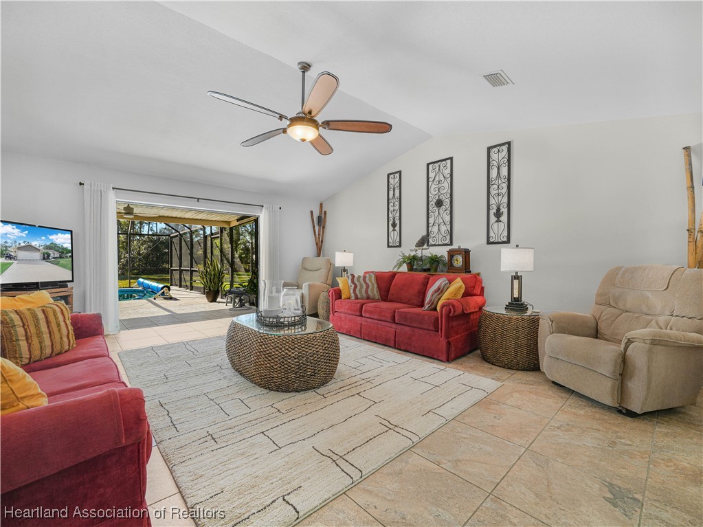 3206 Divot Road Sebring, FL 33872 - Photo 4 of 40 View from DR to LR through stacking sliding glass doors to covered lanai/pool area