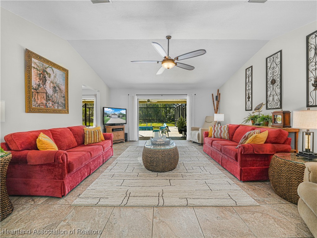 3206 Divot Road Sebring, FL 33872 - Photo 5 of 40 View from DR to LR through stacking sliding glass doors to covered lanai/pool area