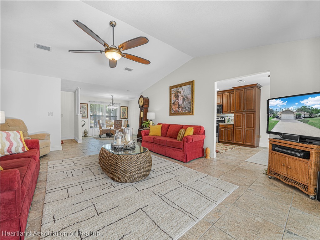 3206 Divot Road Sebring, FL 33872 - Photo 7 of 40 Living Room & Dining Room view from Lanai sliding glass doors - with a glimpse of kitchen