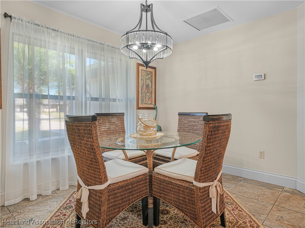 3206 Divot Road Sebring, FL 33872 - Photo 8 of 40 Airy dining room bathed in natural light, positioned in the front of the home