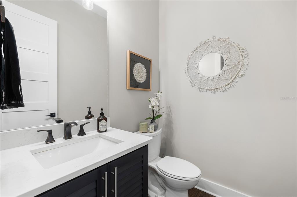 4806 West San Rafael Street Tampa, FL 33629 - Photo 13 of 60 a bathroom with a toilet sink vanity and mirror