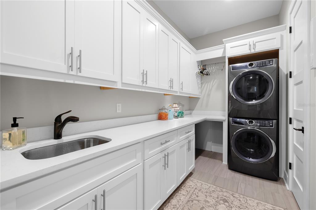 4806 West San Rafael Street Tampa, FL 33629 - Photo 15 of 60 a kitchen with white cabinets and washer