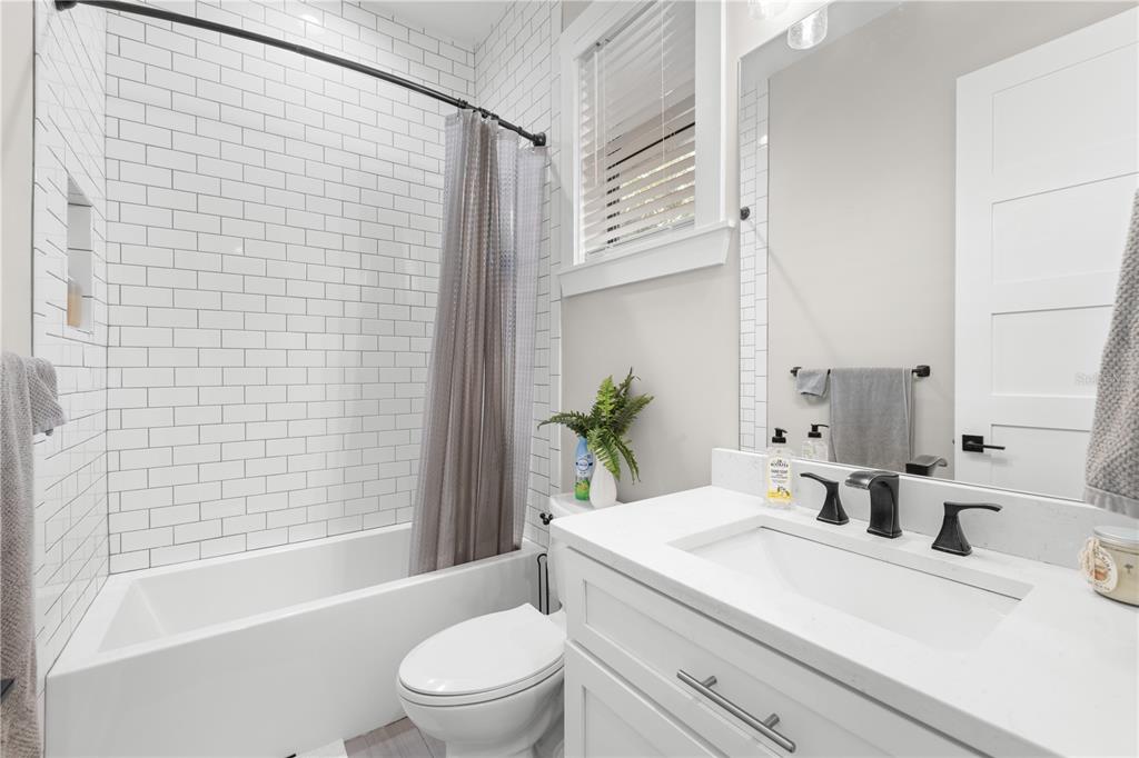 4806 West San Rafael Street Tampa, FL 33629 - Photo 27 of 60 a bathroom with a sink a toilet a mirror and shower