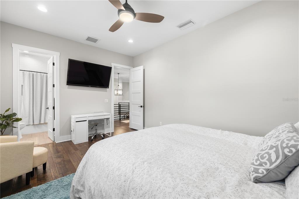 4806 West San Rafael Street Tampa, FL 33629 - Photo 30 of 60 a bedroom with a bed a flat screen tv and a fireplace