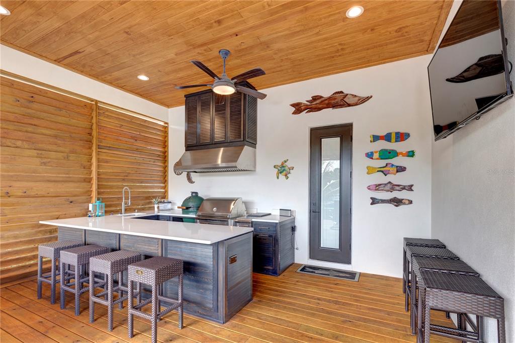 4806 West San Rafael Street Tampa, FL 33629 - Photo 46 of 60 a kitchen with stainless steel appliances kitchen island granite countertop a table chairs in it and wooden floors