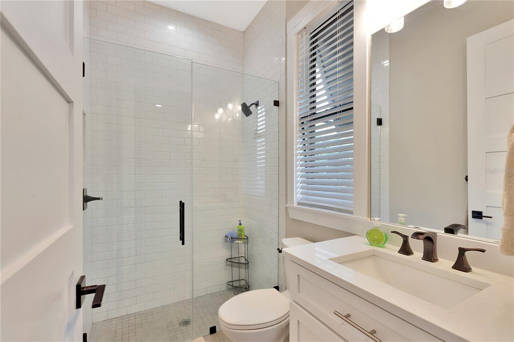 4806 West San Rafael Street Tampa, FL 33629 - Photo 59 of 60 a bathroom with a sink a toilet and shower