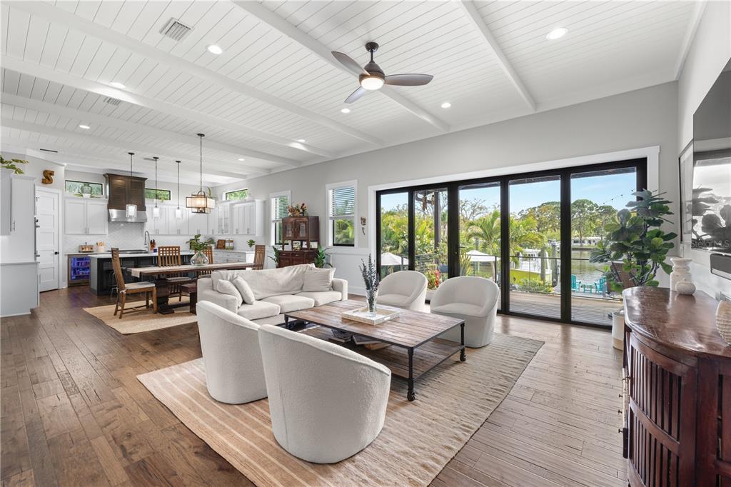 4806 West San Rafael Street Tampa, FL 33629 - Photo 7 of 60 a living room with couches a dining table and chairs with wooden floor