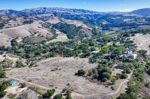 an aerial view of mountain with yard