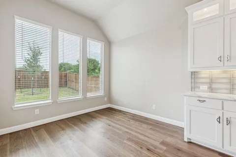 a view of kitchen with refrigerator and window