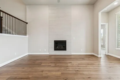 a view of kitchen with wooden floor and electronic appliances