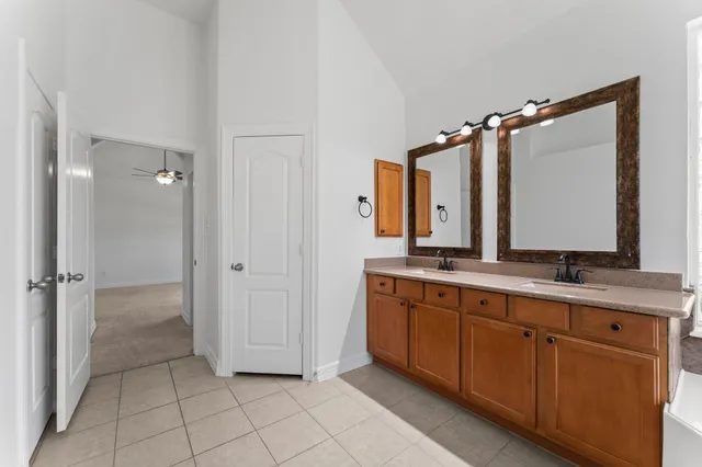 a bathroom with a double vanity sink mirror and double