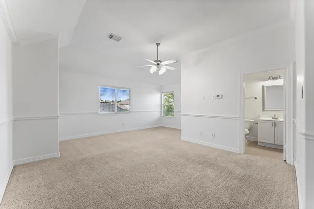 a view of a room with an empty space and a window