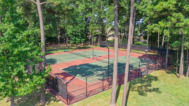 front view of a house with a yard and potted plants