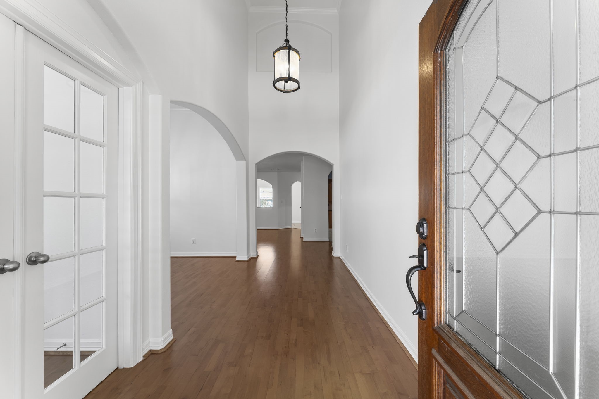 3131 Rustic Gardens Drive Spring, TX 77386 - Photo 4 of 39 a view of a hallway with wooden floor and staircase