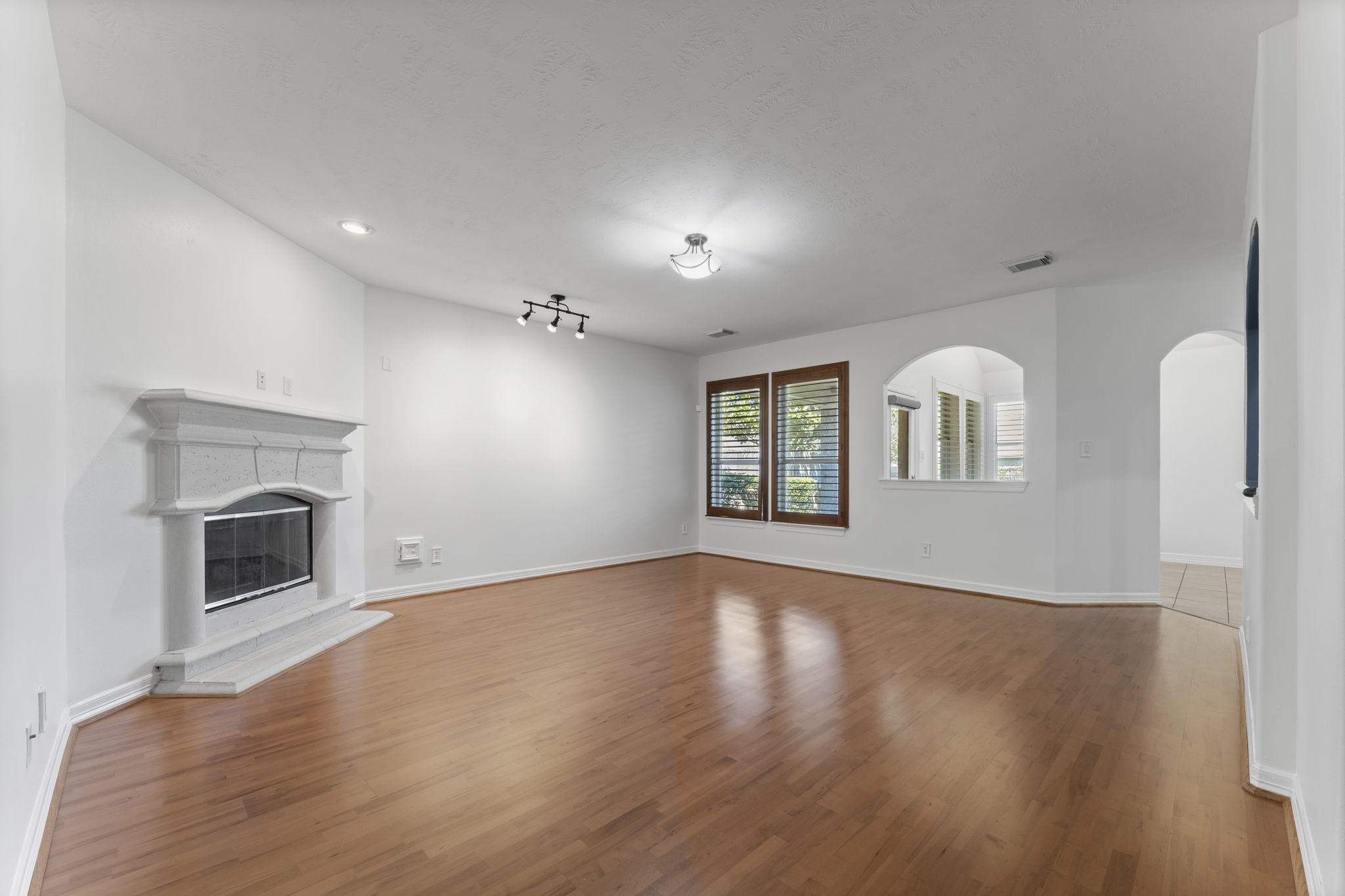3131 Rustic Gardens Drive Spring, TX 77386 - Photo 8 of 39 a view of an empty room with a fireplace and a window