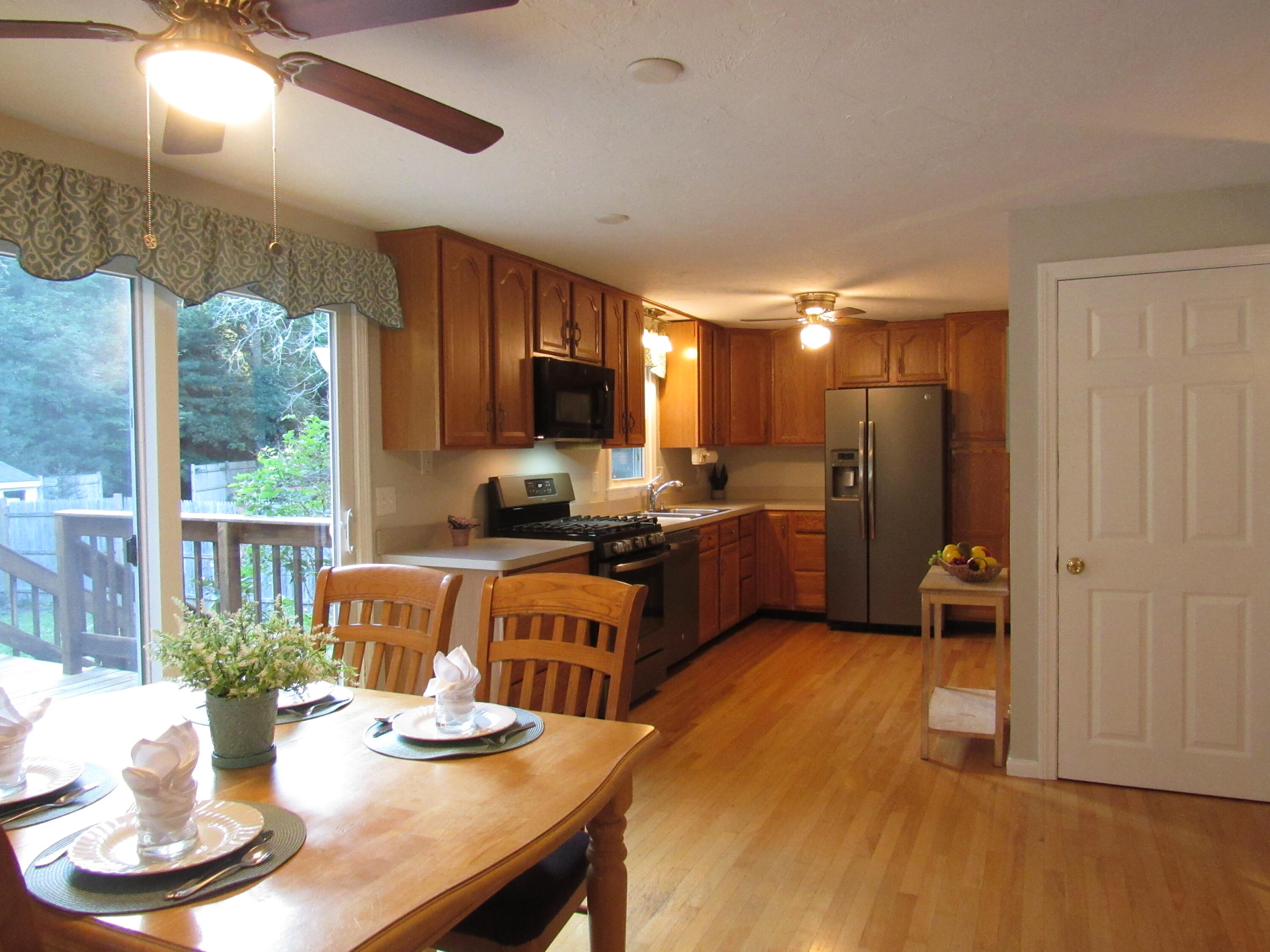249 Ames Way Centerville, MA 02632 - Photo 11 of 41 a living room with stainless steel appliances kitchen island granite countertop furniture and a wooden floor
