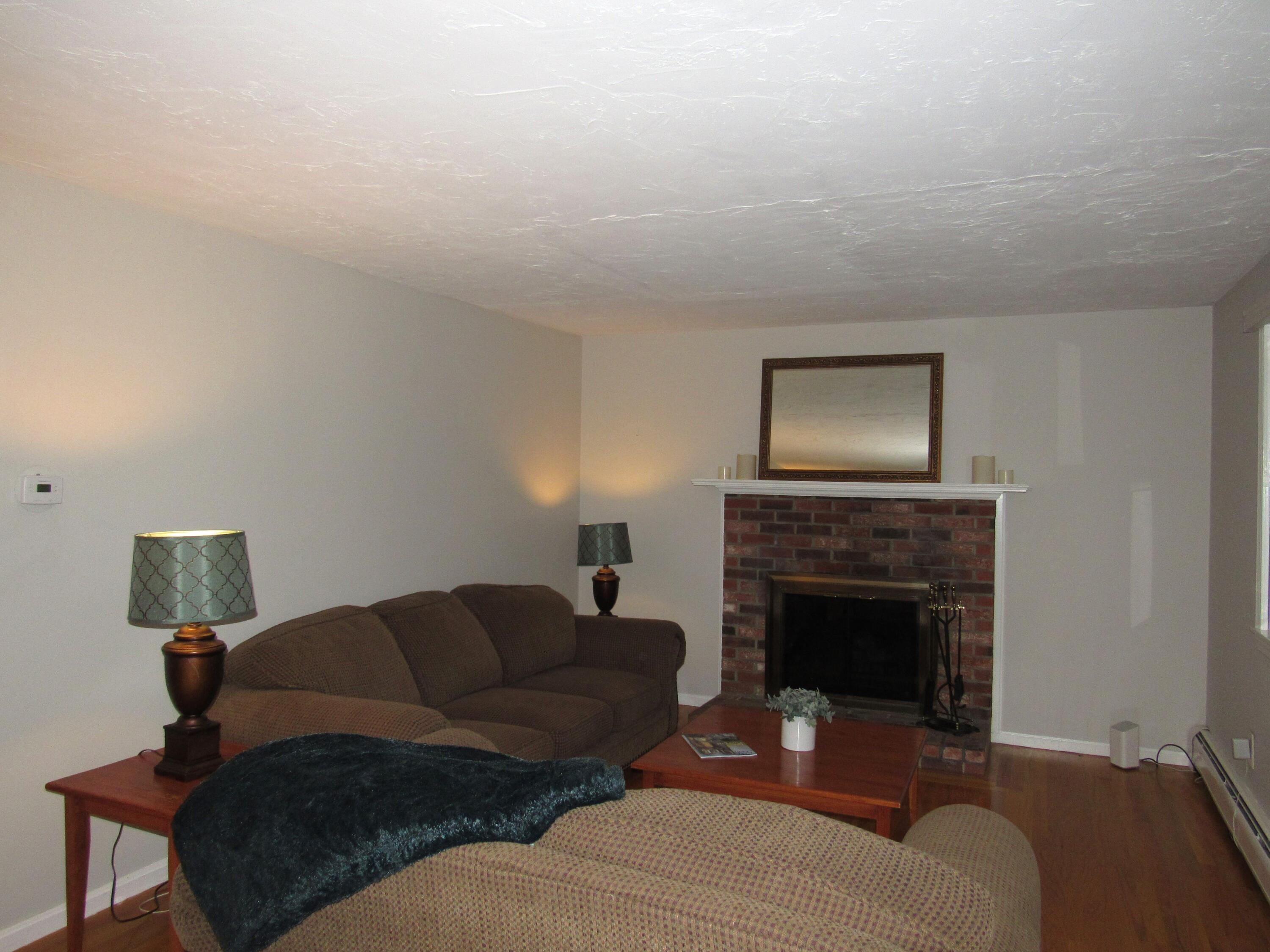 249 Ames Way Centerville, MA 02632 - Photo 20 of 41 a living room with furniture a fireplace and a flat screen tv