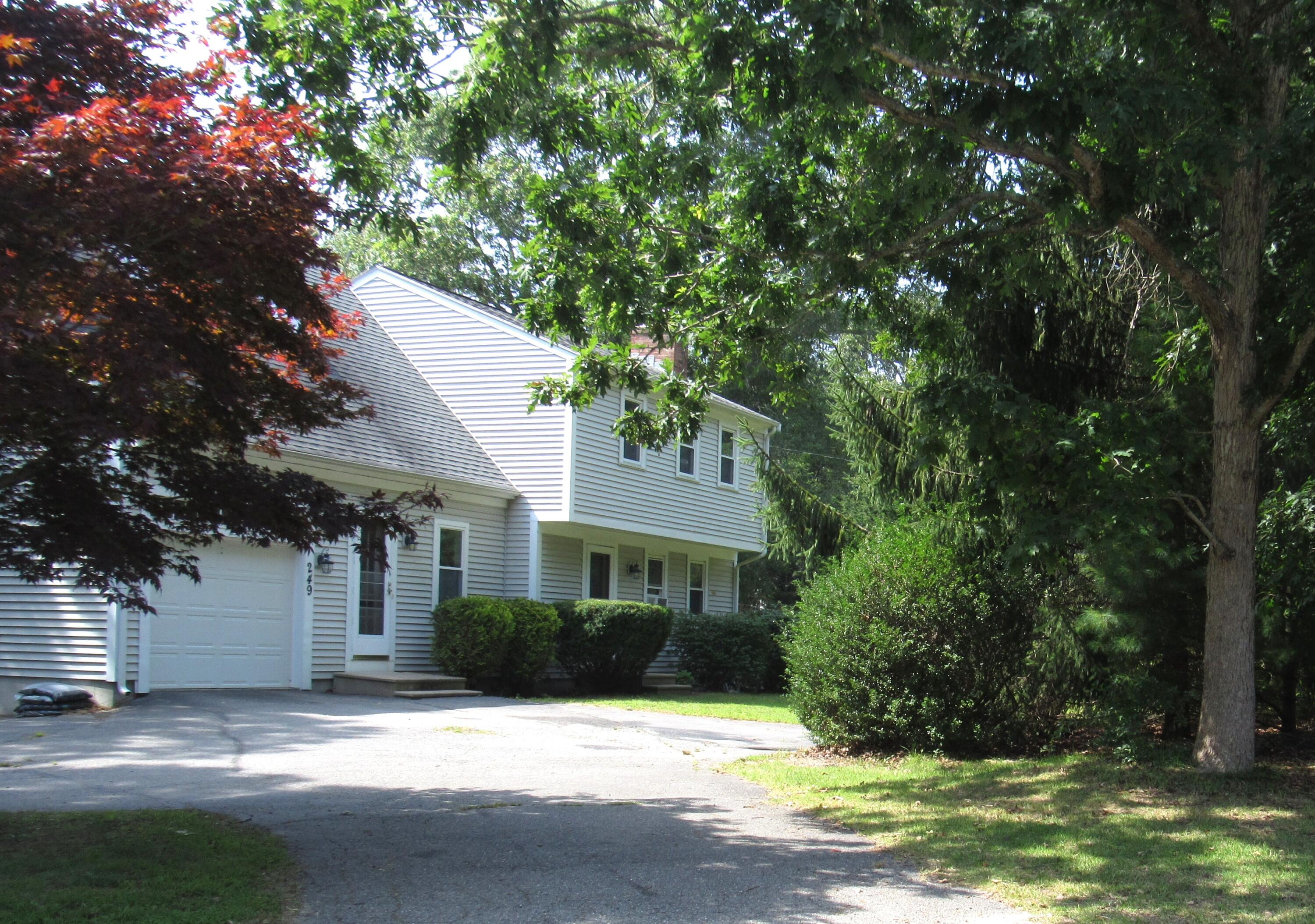 249 Ames Way Centerville, MA 02632 - Photo 2 of 41 a front view of a house with a yard and garage