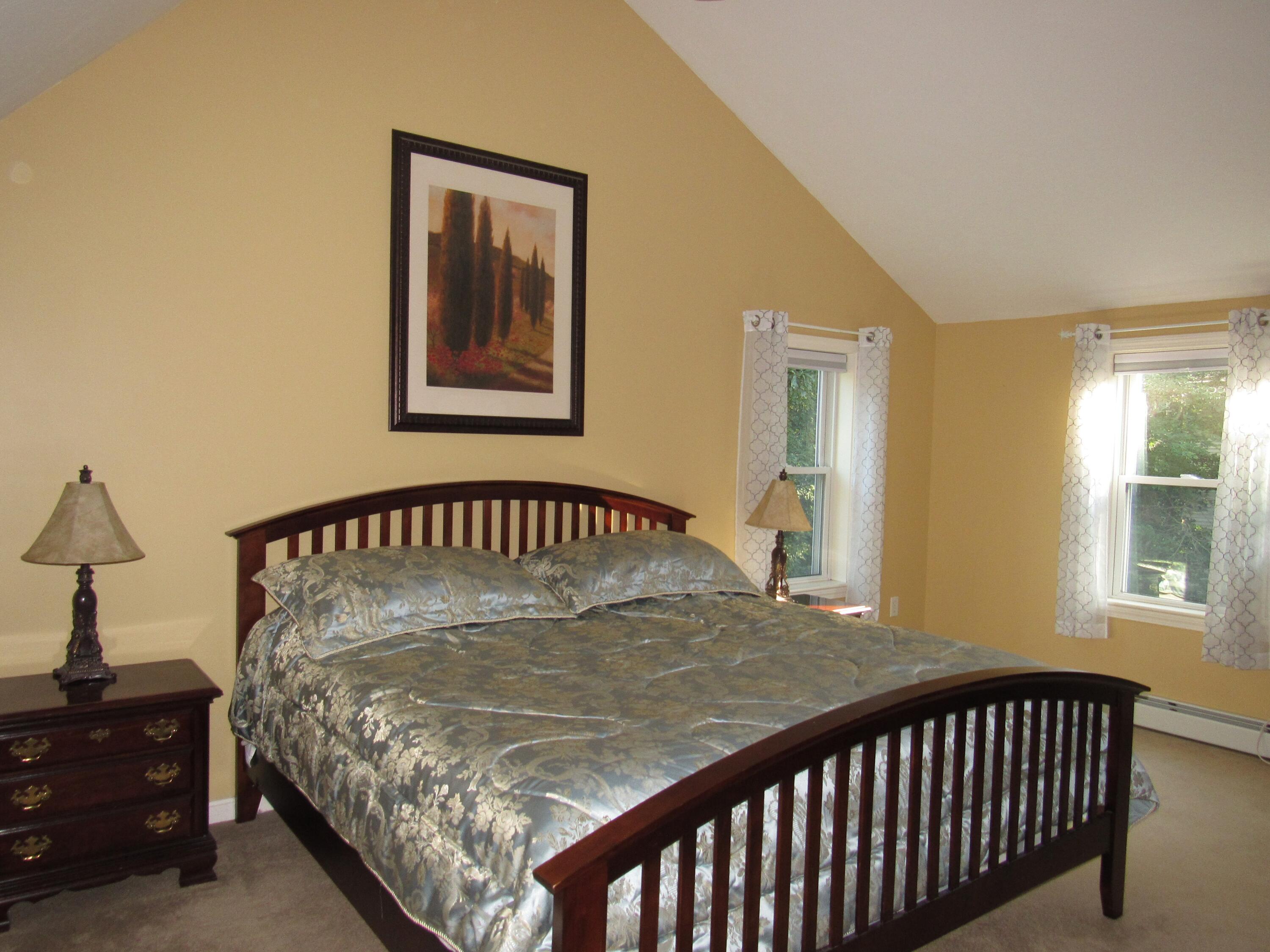249 Ames Way Centerville, MA 02632 - Photo 23 of 41 a bed sitting in a bedroom next to a window